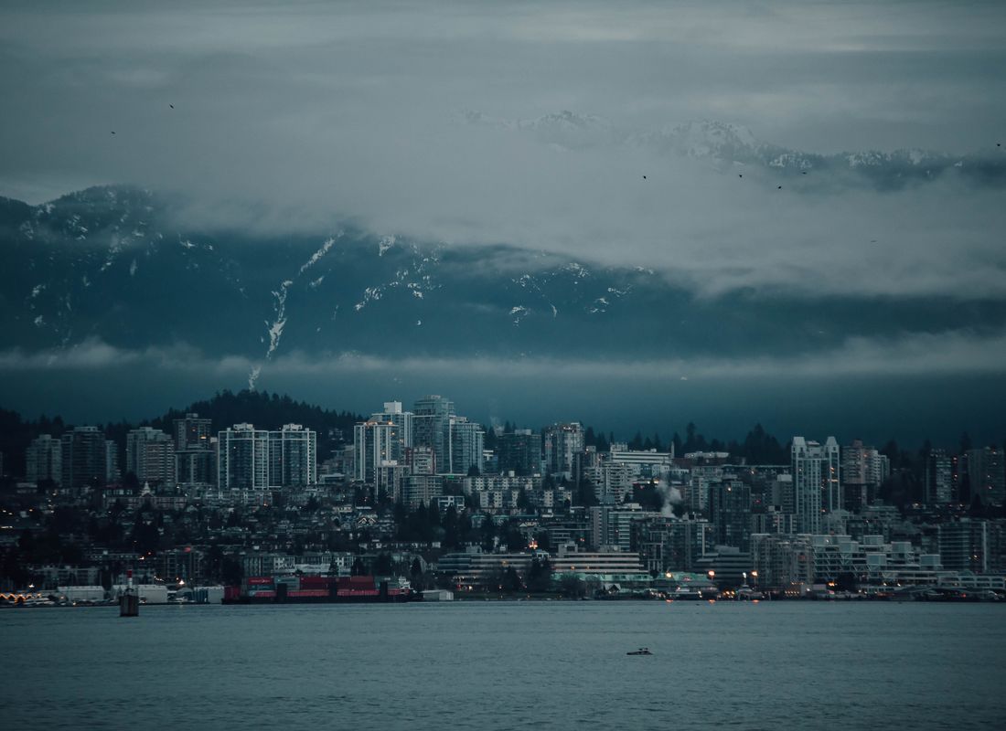 Homes on the British Columbia coast with mountains behind