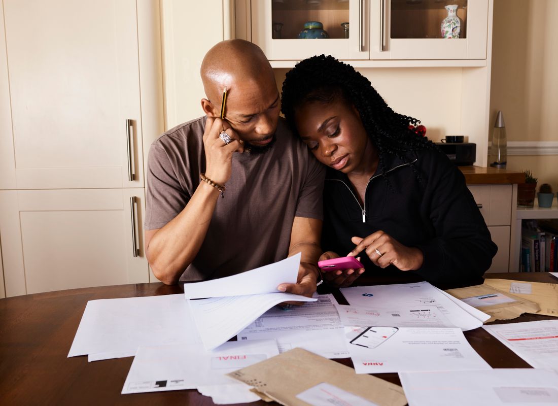 A couple reviewing solar paperwork at their kitchen table