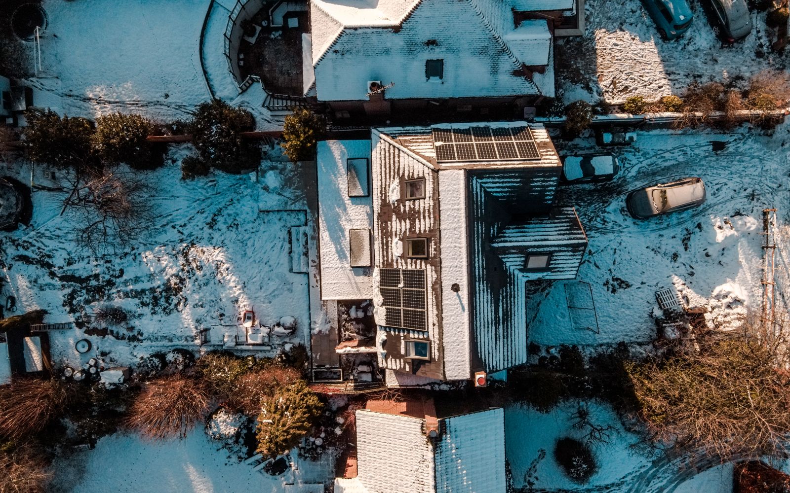 Rooftop solar panels on a Canadian home with snow on the ground in low winter light